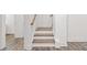 This lovely staircase features wood stairs and white risers and posts at 3409 Catalan Aly, Decatur, GA 30032