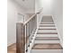 Staircase featuring stained wood treads, white risers, and iron spindles at 3409 Catalan Aly, Decatur, GA 30032