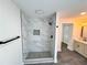 Bathroom showcasing a glass-enclosed shower with marble tile, matte black hardware, and a pebble floor at 6751 Davidson Ct, Lithonia, GA 30058