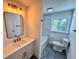 Updated bathroom with modern vanity, updated fixtures, and tub shower at 6751 Davidson Ct, Lithonia, GA 30058