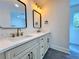 Bathroom features a double vanity, modern mirrors, and elegant fixtures at 6751 Davidson Ct, Lithonia, GA 30058