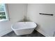 Bathroom featuring a freestanding soaking tub, black hardware, and a bright window at 6751 Davidson Ct, Lithonia, GA 30058