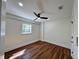 Comfortable bedroom with hardwood floors, ceiling fan, and a bright window at 6751 Davidson Ct, Lithonia, GA 30058