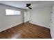 Bright bedroom features hardwood floors, a modern ceiling fan, and a window for natural light at 6751 Davidson Ct, Lithonia, GA 30058