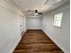 Large room featuring vinyl floors, modern ceiling fan, and backyard views at 6751 Davidson Ct, Lithonia, GA 30058