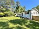 Classic white exterior with black shutters and a spacious front yard and side fence at 6751 Davidson Ct, Lithonia, GA 30058