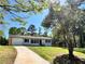 View of the home with a winding concrete driveway and a beautiful lush green lawn at 6751 Davidson Ct, Lithonia, GA 30058