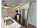 Bright kitchen features stainless steel appliances, white cabinets, and a sleek island with gold fixtures at 6751 Davidson Ct, Lithonia, GA 30058