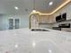 Close-up of the kitchen island, which features light countertops and brushed gold faucet at 6751 Davidson Ct, Lithonia, GA 30058
