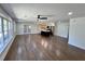 Open-concept living space with hardwood floors and a view into a stylish kitchen at 6751 Davidson Ct, Lithonia, GA 30058