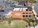 Aerial view of a commercial area with city center signage, ample parking, landscaping, and multiple buildings at 3375 Hillshire Dr, Cumming, GA 30028