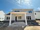 New home exterior featuring a covered porch with columns and an unfinished backyard ready for landscaping at 3375 Hillshire Dr, Cumming, GA 30028
