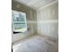 A bedroom under construction is shown with drywall, a window and unfinished floors at 3375 Hillshire Dr, Cumming, GA 30028