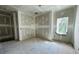 A bedroom is shown during the construction phase, with drywall and a window to the outside at 3375 Hillshire Dr, Cumming, GA 30028