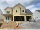 New two-story home with unfinished landscaping and a spacious three-car garage awaiting customization at 3375 Hillshire Dr, Cumming, GA 30028