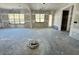 Bright unfinished living room with natural light pouring through large windows, highlighting the open layout at 3375 Hillshire Dr, Cumming, GA 30028