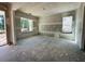 Bright, unfinished living room boasts abundant natural light with open doorway to the outdoor space at 3375 Hillshire Dr, Cumming, GA 30028