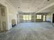 Expansive living room showing incomplete drywall, large windows, and versatile layout at 3375 Hillshire Dr, Cumming, GA 30028