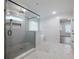 Modern bathroom featuring a glass shower, soaking tub, and marble-look tile at 4201 Hosch Reserve Dr, Buford, GA 30519