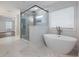 Luxurious primary bathroom with a glass shower and a white soaking tub at 4201 Hosch Reserve Dr, Buford, GA 30519