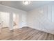 Spacious bedroom with plank flooring, decorative wall trim, and doorways at 4201 Hosch Reserve Dr, Buford, GA 30519