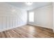 Bedroom with plank floors, a window, and decorative white wall trim at 4201 Hosch Reserve Dr, Buford, GA 30519