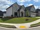 A beautiful two-story home with light gray siding and a well-manicured front yard at 4201 Hosch Reserve Dr, Buford, GA 30519