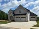 New two-story home featuring a two-car garage, concrete driveway, and manicured lawn at 4201 Hosch Reserve Dr, Buford, GA 30519