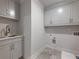A modern laundry room offers plenty of storage and a sink at 4201 Hosch Reserve Dr, Buford, GA 30519