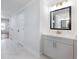 Hallway view of a bathroom with a modern sink and cabinet, alongside a full mirror at 4201 Hosch Reserve Dr, Buford, GA 30519