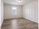 This bedroom features new floors, board and batten accent wall, and a window with a view of the outdoors at 4201 Hosch Reserve Dr, Buford, GA 30519