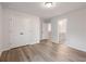 Bright bedroom features a closet, ensuite bathroom, and wood-look flooring at 4201 Hosch Reserve Dr, Buford, GA 30519