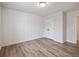 Modern bedroom with stylish wood-look flooring, vertical wall paneling and a closet at 4201 Hosch Reserve Dr, Buford, GA 30519