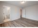 This bedroom features an ensuite bathroom and a closet with wood-look flooring at 4201 Hosch Reserve Dr, Buford, GA 30519