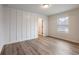 This bedroom features board and batten, modern floors, a window, and an ensuite bath and closet at 4201 Hosch Reserve Dr, Buford, GA 30519