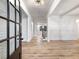 Inviting foyer with wood flooring, white wainscoting and trim, and a decorative light fixture at 4201 Hosch Reserve Dr, Buford, GA 30519