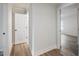 Hallway with wood-look floors leading to a bedroom and closet at 4201 Hosch Reserve Dr, Buford, GA 30519