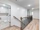 Second floor landing with decorative railing and access to the laundry room at 4201 Hosch Reserve Dr, Buford, GA 30519