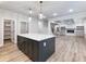 Spacious kitchen with large island, ample cabinet space, hardwood floors, and stainless steel appliances at 4201 Hosch Reserve Dr, Buford, GA 30519