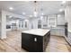 Open kitchen concept with island, modern lighting, stainless steel appliances, and hardwood floors at 4201 Hosch Reserve Dr, Buford, GA 30519