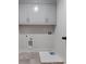 A dedicated laundry room with gray cabinets, gray floors and utility connections at 4201 Hosch Reserve Dr, Buford, GA 30519