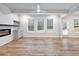 Bright living room featuring hardwood floors, modern fireplace, built-ins, and plenty of natural light at 4201 Hosch Reserve Dr, Buford, GA 30519