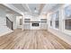 Stylish living room featuring wood floors, a fireplace, built-in cabinets, and large windows at 4201 Hosch Reserve Dr, Buford, GA 30519