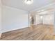 Spacious living room with wood flooring, white trim, and stairs leading to the second floor at 4201 Hosch Reserve Dr, Buford, GA 30519