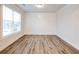 Cozy office with wood flooring, white wainscoting detail, and a large window at 4201 Hosch Reserve Dr, Buford, GA 30519
