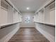 A well-organized walk-in closet with open shelving, wood flooring and window at 4201 Hosch Reserve Dr, Buford, GA 30519
