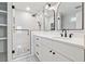 Bathroom featuring marble floors, glass enclosed shower and white vanity at 705 Trickum Valley Dr, Woodstock, GA 30188