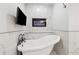 Luxurious bathroom showcasing a freestanding tub, fireplace and a TV at 705 Trickum Valley Dr, Woodstock, GA 30188