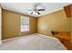 Bedroom featuring neutral carpet, a ceiling fan, and a window with built-in desk at 705 Trickum Valley Dr, Woodstock, GA 30188