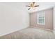 Cozy bedroom with neutral carpet, a ceiling fan, and a window at 705 Trickum Valley Dr, Woodstock, GA 30188